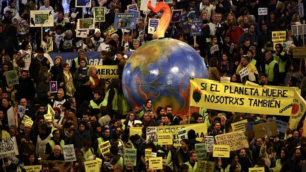 Demonstrators with a balloon in the shape of the Earth take part in a mass climate march