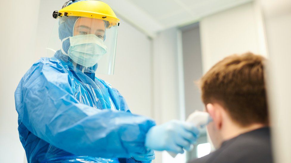 WHO guidelines, which currently recommend health staff wear a full gown and visor.