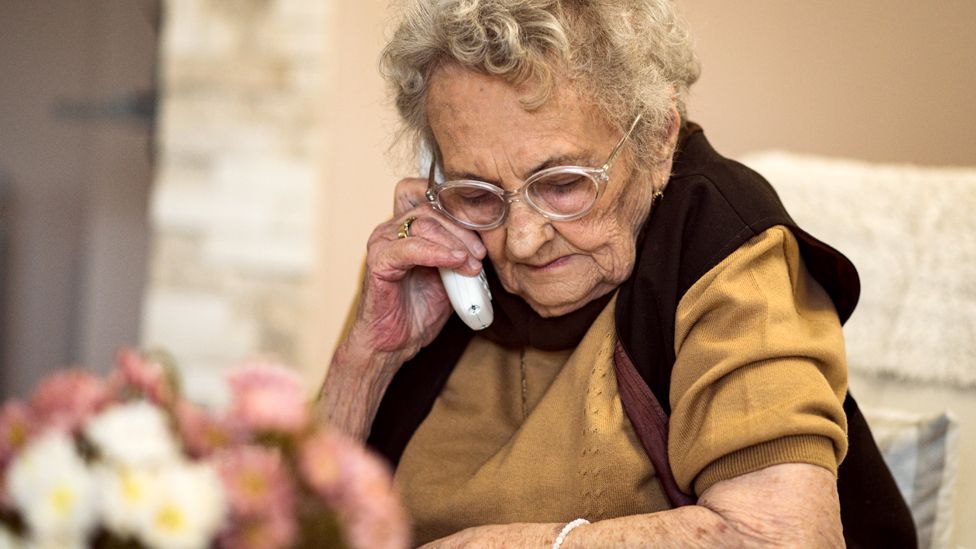 Elderly woman on a landline phone
