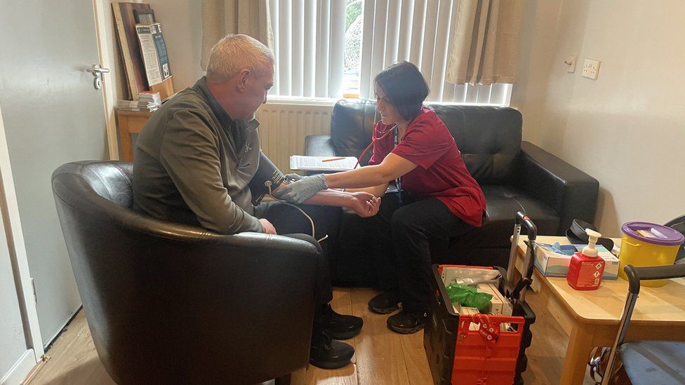 Lisa treating a patient at the Simon Community hostel in Lisburn
