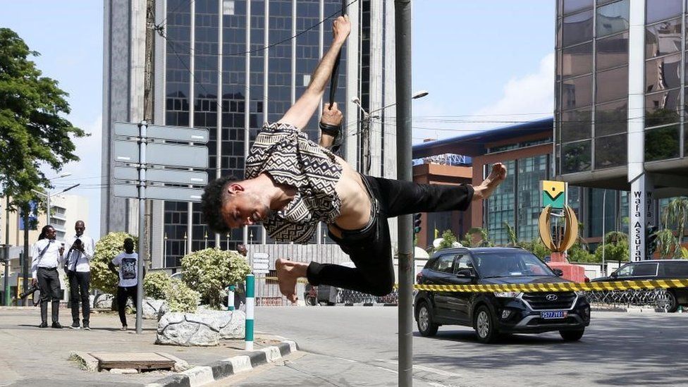 A member of the Moroccan Circus performs during street performances on the occasion of the opening of the 6th edition of the Rencontres Interculturelles du Cirque d'Abidjan (RICA), in Abidjan, Ivory Coast, 15 March 2023. RICA will be held for six days at the French Institute in Abidjan. Ten countries including France, Japan, Brazil, Ivory Coast, Morocco, Burkina Faso, Canada, Italy, Nigeria and Switzerland are taking part.