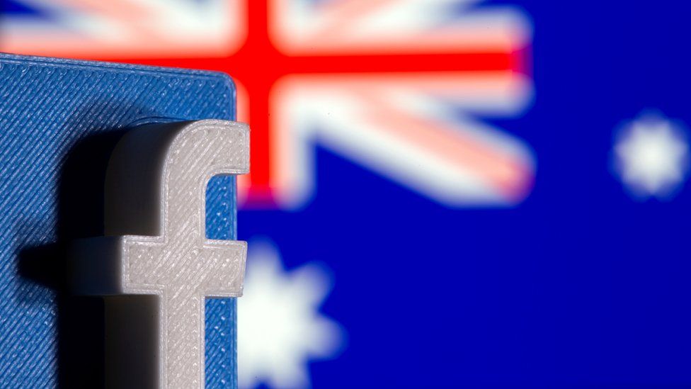 A 3D printed Facebook logo is seen in front of displayed Australia"s flag in this illustration photo taken February 18, 2021.