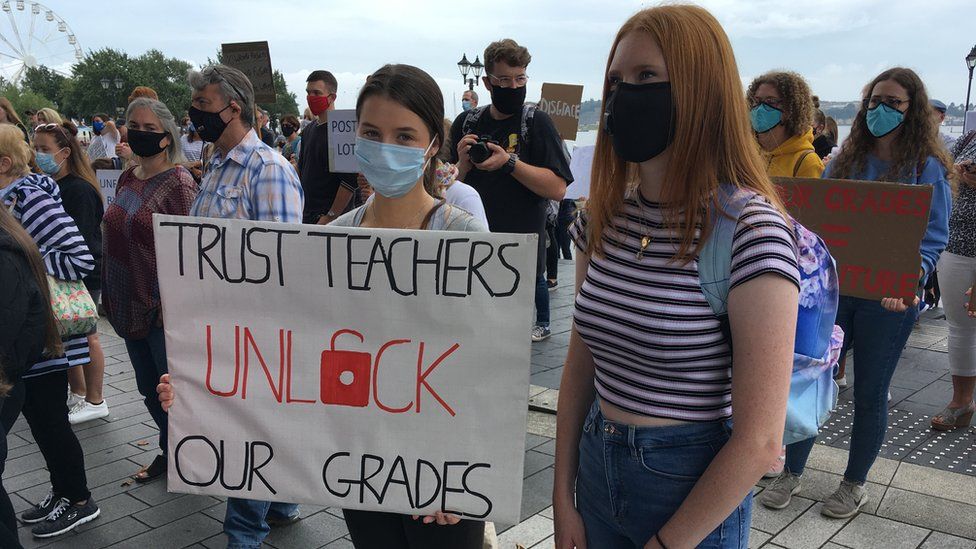 Students holding placard calling for grades to be unlocked