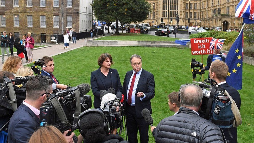 Arlene Foster and Nigel Dodds talk to reporters outside the House of Commons