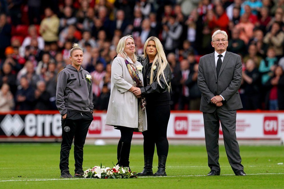 Maddy Cusack's mum and sister on the pitch after laying a wreath in memory of her, ahead of the Premier League match at Bramall Lane, Sheffield, on 24 September 2023