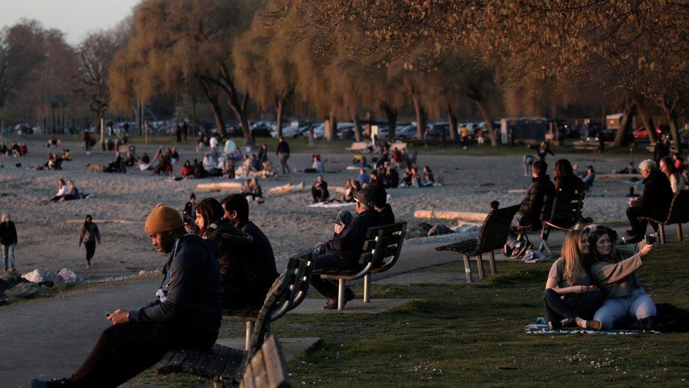 People gather at sunset, during the coronavirus disease (COVID-19) outbreak, at Golden Gardens Park in Seattle, Washington, U.S. March 21, 2020