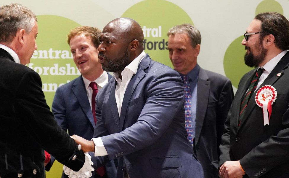 Festus Akinbusoye shakes hands with the returning officer