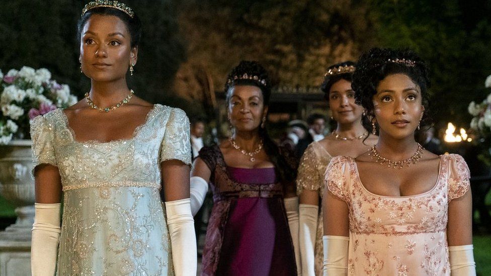 Bridgerton. (L to R) Simone Ashley as Kate Sharma, Adjoa Andoh as Lady Danbury, Shelley Conn as Mary Sharma, Charithra Chandran