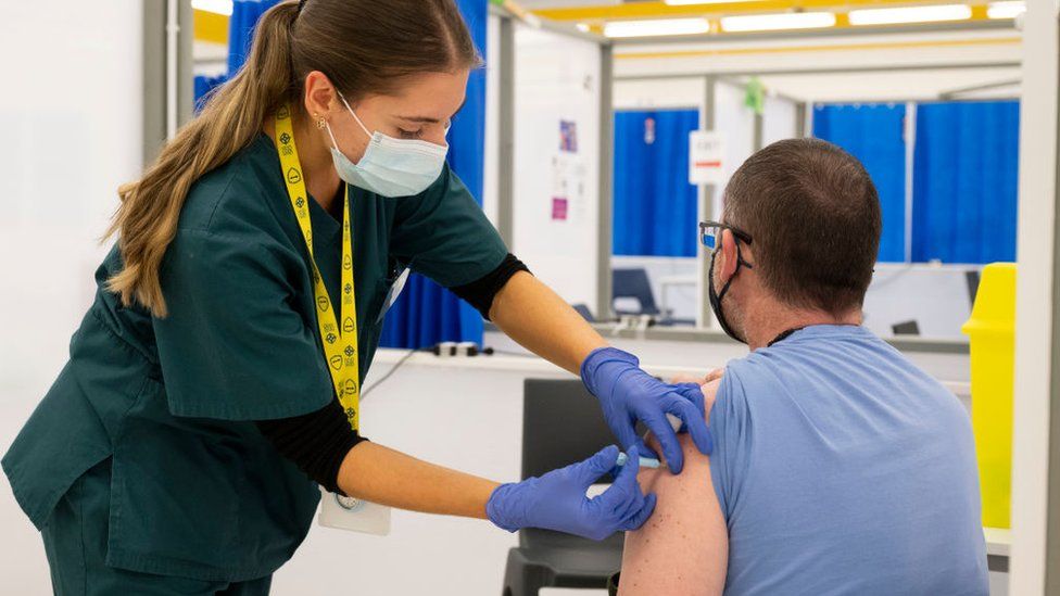 A man is vaccinated at the Cardiff Bay mass vaccination centre