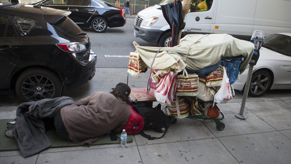 Homeless man sleeps on the street in San Francisco (file photo)