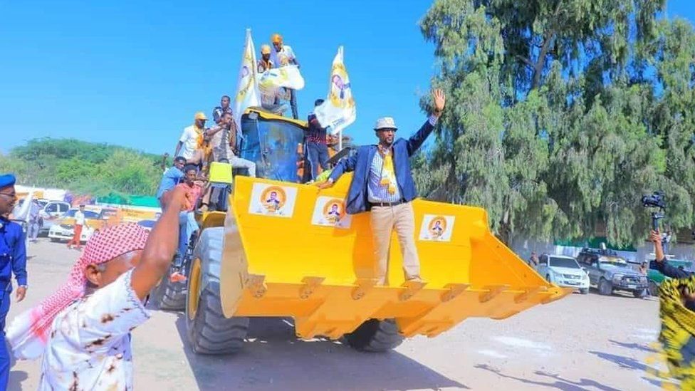 Barkhad Jama Hersi Batun and other members of the Waddani party on the campaign trail on a bulldozer