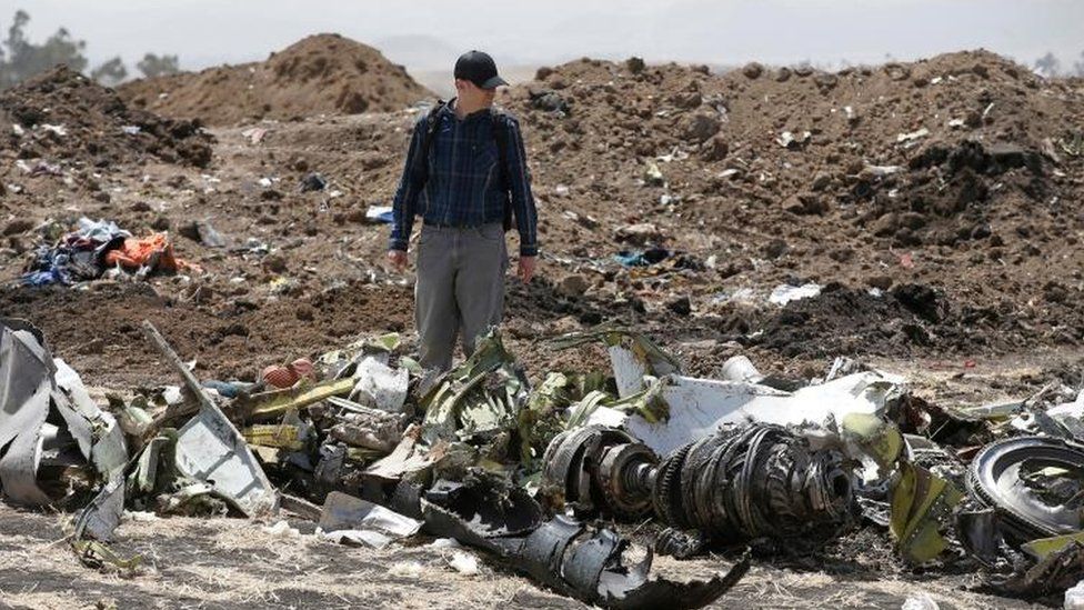 American civil aviation and Boeing investigators search through the debris at the scene of the Ethiopian Airlines Flight ET 302 plane crash