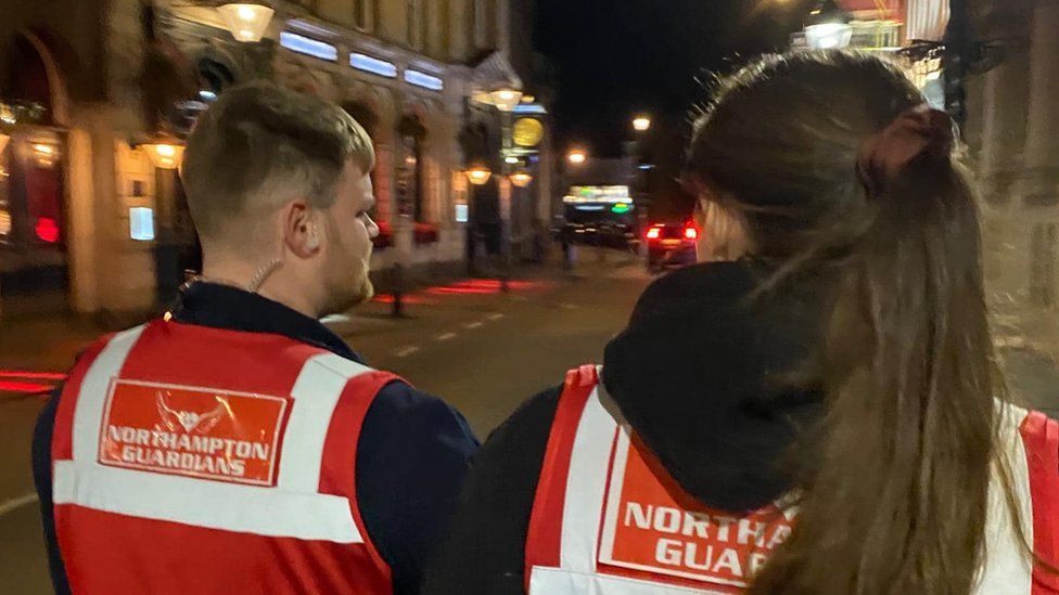 Two volunteers walking in Northampton Town Centre at night