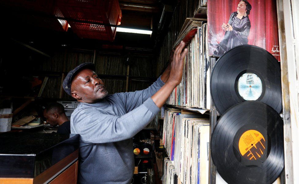 A man arranges vinyl records at his stall number that specializes in selling second-hand vinyl records and restoration of vintage players at the Kenyatta Market in Nairobi, Kenya - Thursday 24 November 2016