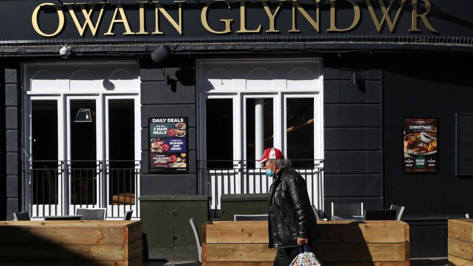 Man walks past pub in Cardiff