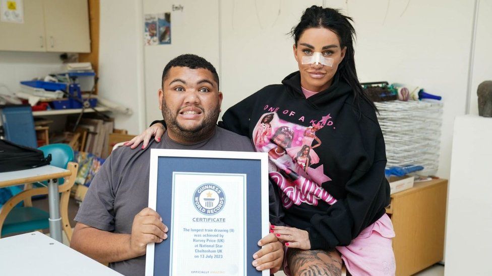 Katie Price and Harvey Price holding his Guinness World Record certificate