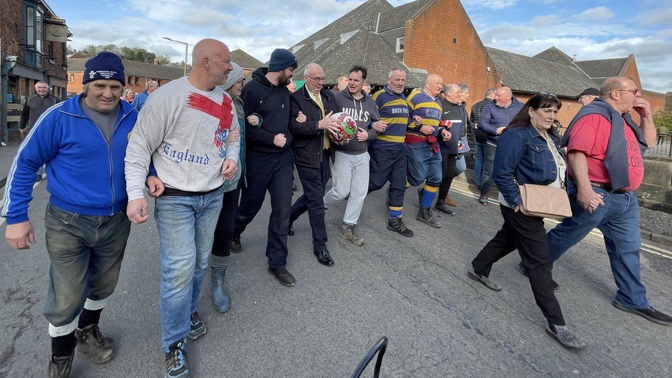 Fans escort Paul Cook