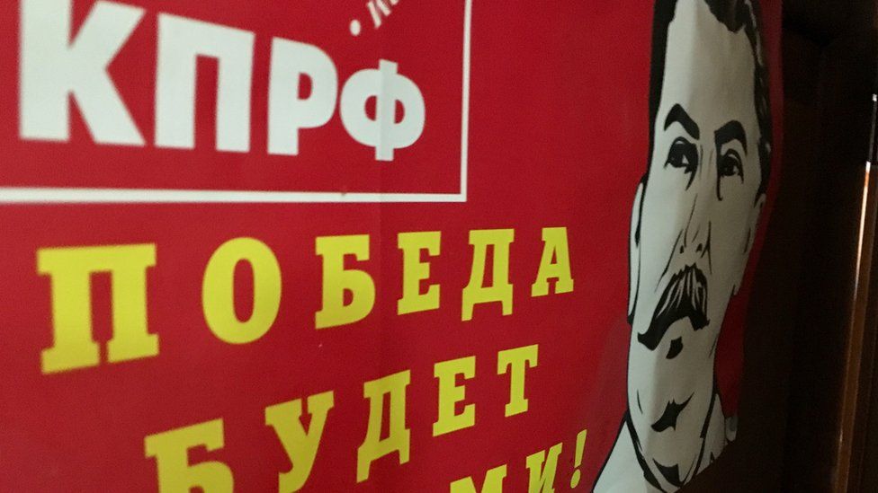 "Victory will be ours," proclaims a Communist Party poster, complete with image of Josef Stalin