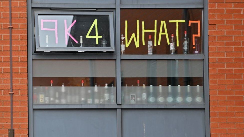 Students stick messages on the windows of their accommodation while self-isolating