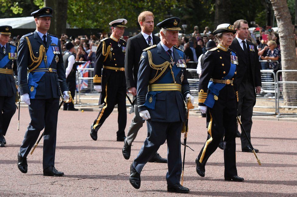 Prince William, Prince of Wales, Prince Harry, Duke of Sussex, Peter Phillips (front row) King Charles III and Princess Anne, Princess Royal walk behind the coffin during the procession for the Lying-in State of Queen Elizabeth II