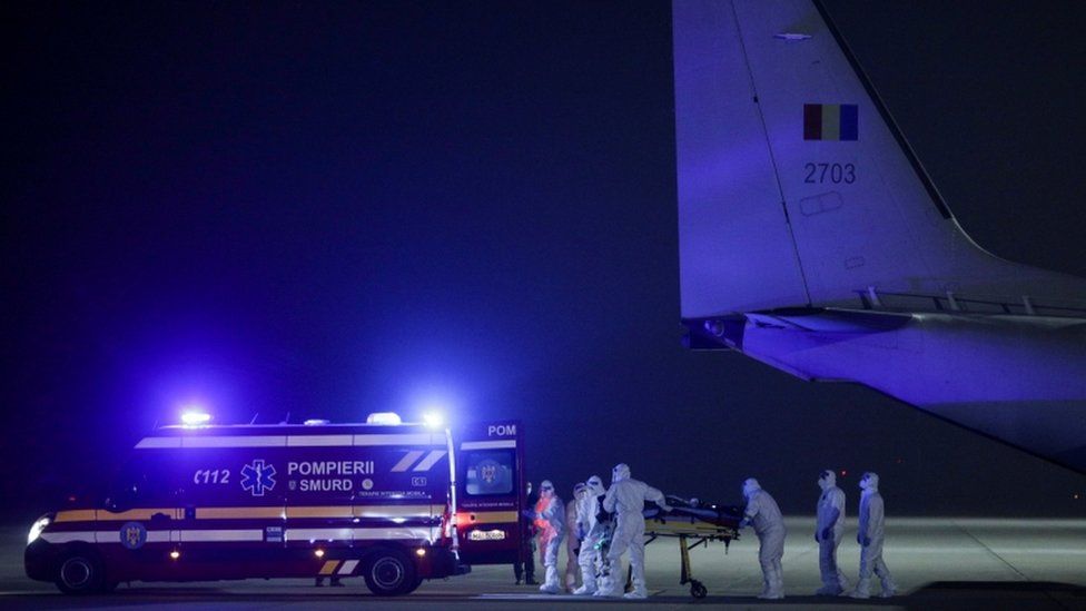 Medical staff transfer Dr Catalin Denciu from a from a military airplane to an ambulance, in Otopeni, Ilfov, Romania, on 15 November 2020