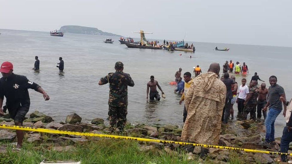 Rescue workers around the submerged plane