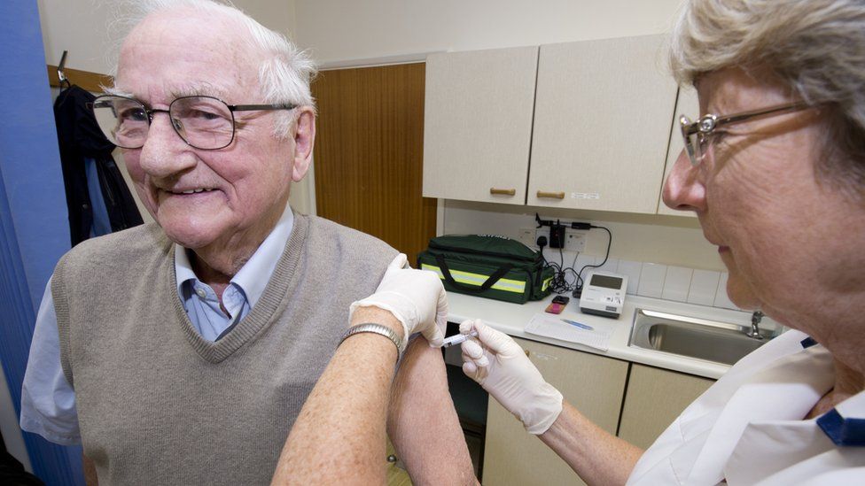 Elderly man gets flu jab