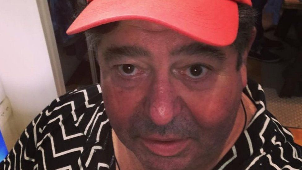 Picture of Rob Goldstone wearing a hat saying "Out of office"