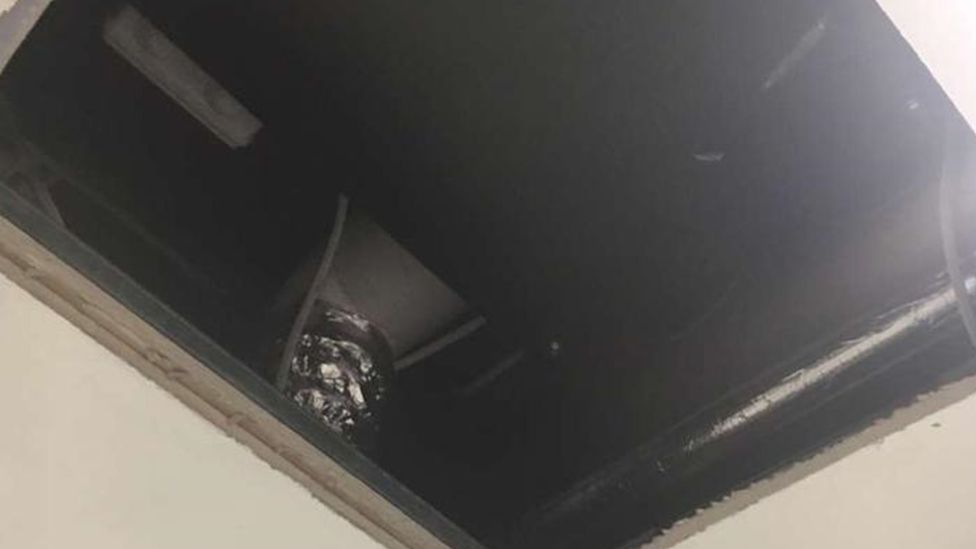 A large hole in the bathroom ceiling