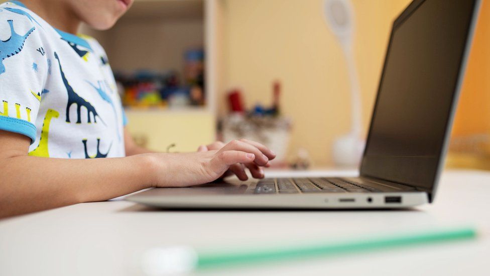 Stock image of a child using a laptop