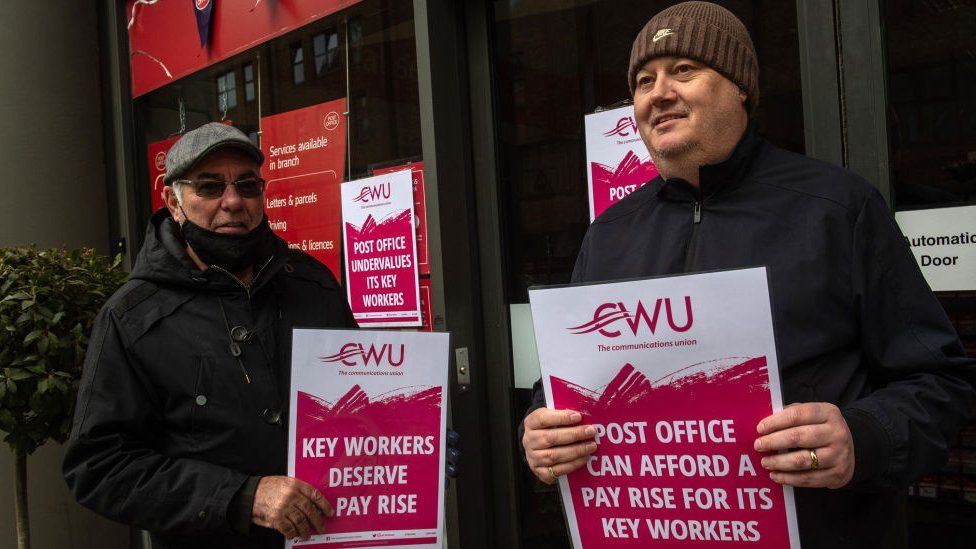 Members of the Communication Workers Union (CWU) picket the Crown Post Office in Paddington during their strike over pay on 4 June