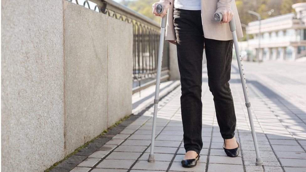 Woman on crutches