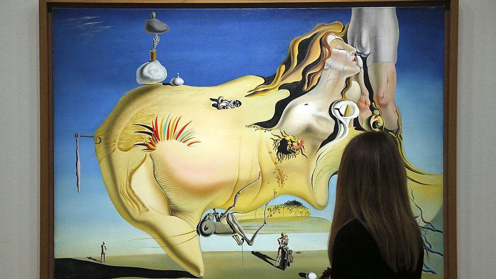 A visitor looks at a painting, The Great Masturbator, by Spanish surrealist artist Salvador Dali during an exhibition of his work at the Centre Pompidou in Paris on 19 November 2012