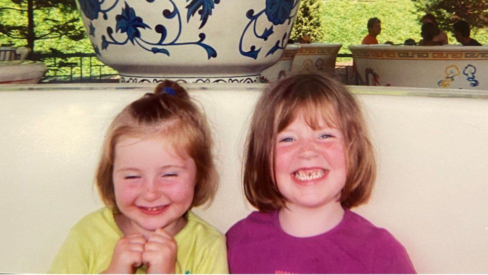 Katie with her sister as a child