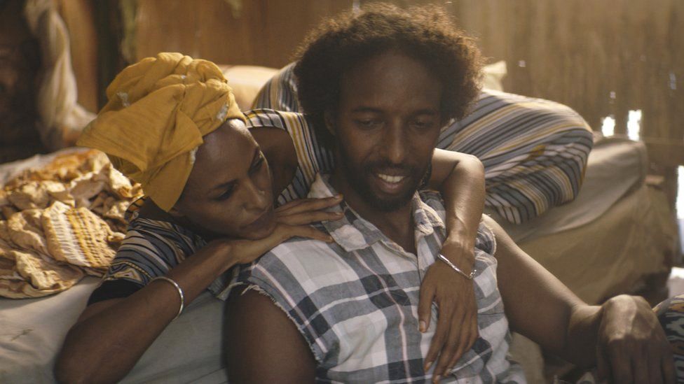 Still from film showing couple embracing