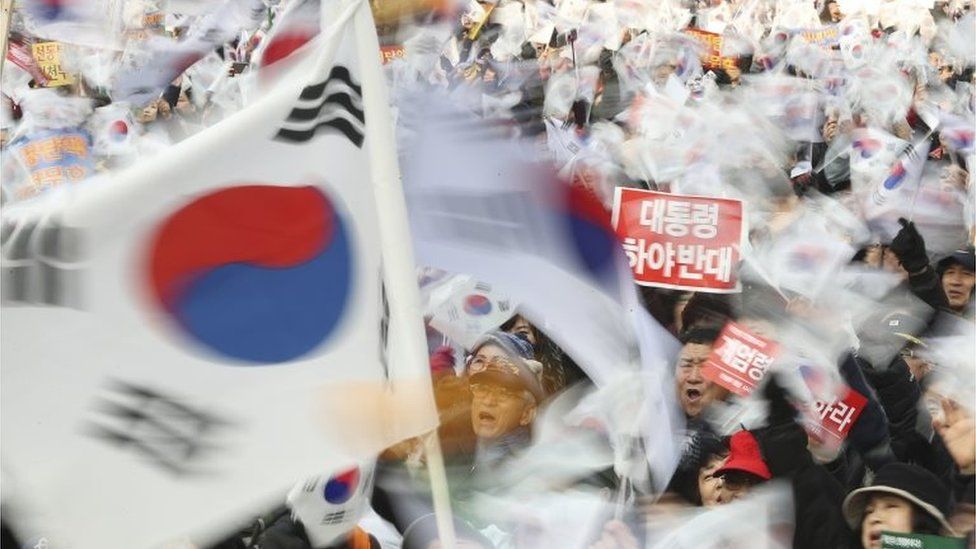 Supporters of South Korean President Park Geun-hye wave their national flags during a rally opposing her impeachment in Seoul, South Korea, on 31 December