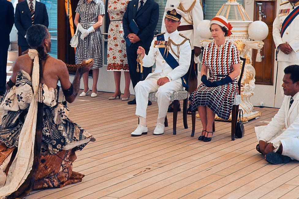 Queen Elizabeth ll and Prince Philip, Duke of Edinburgh receive and are entertained by Fijian folk and traditional dancers on board the Royal Yacht Britannia on 16 February 1977 in Fiji.