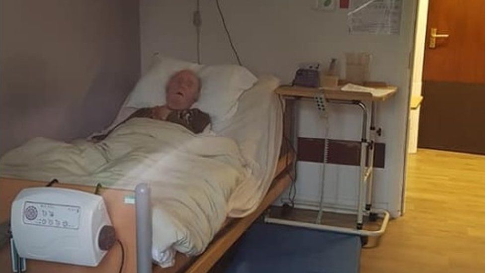 Mr Dunbar in bed at the care home