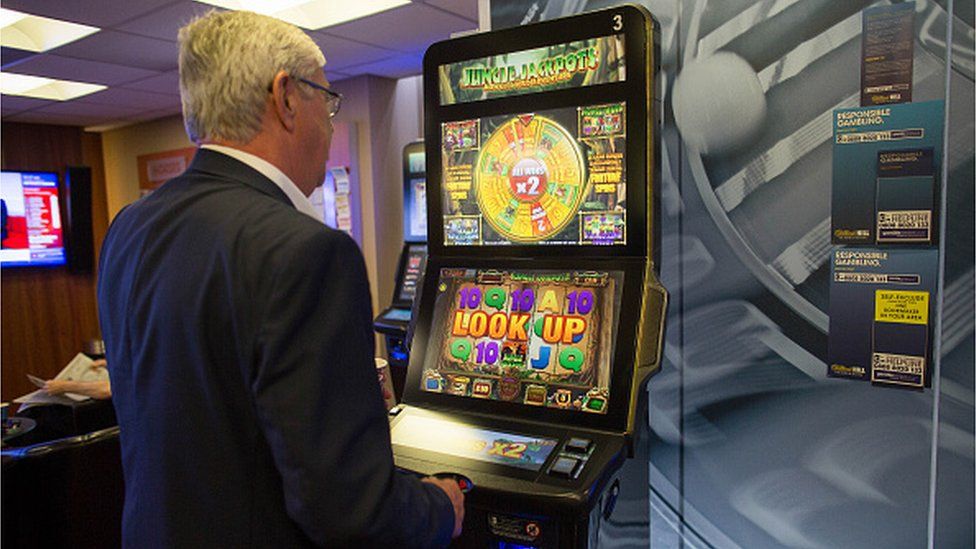 A customer plays a slot machine at a William Hill