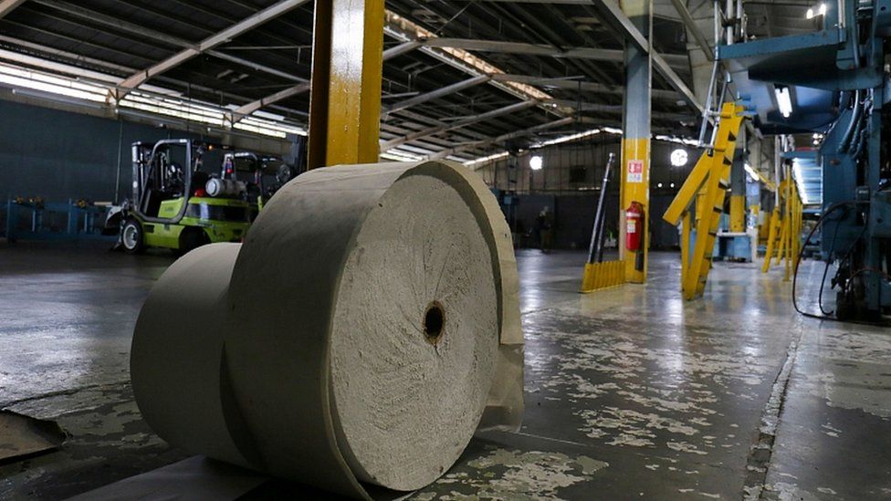 A roll of paper is seen at the printing press of La Prensa
