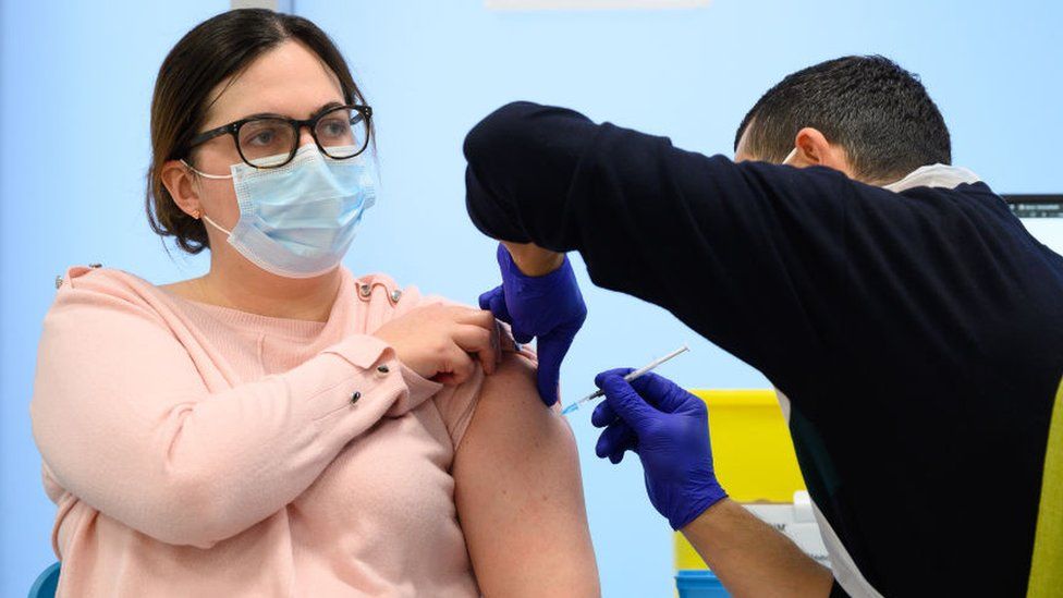 Woman getting booster vaccine