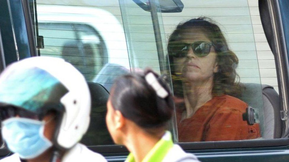 Australian national Tammy Davis-Charles (R), 49, sits in a prison car as she travels to Phnom Penh municipal court on 13 June 2017