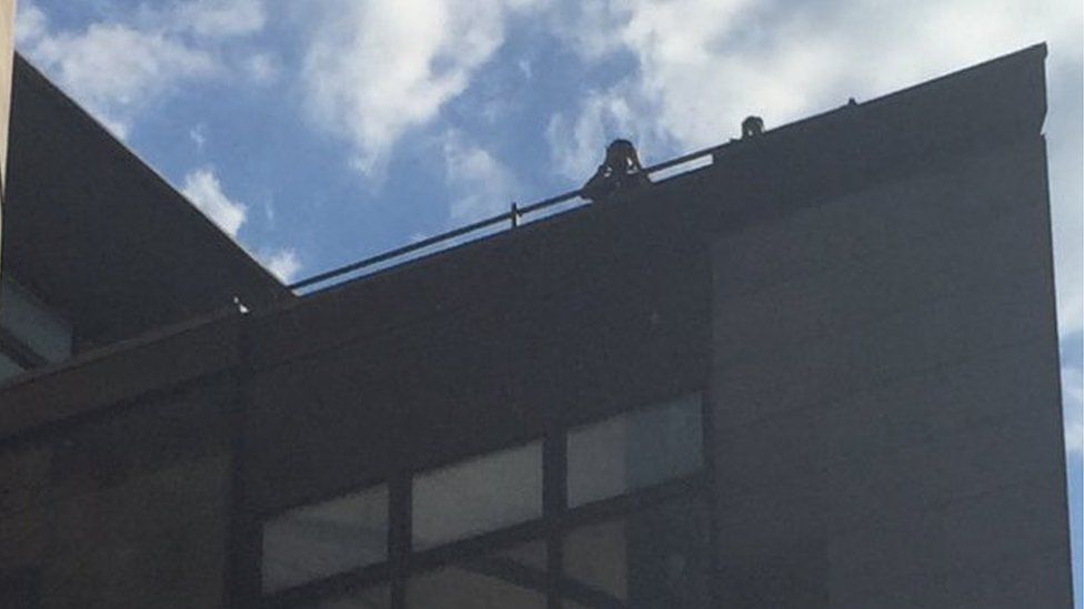 Police officers on roof