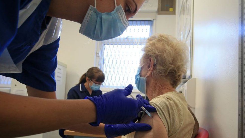 An older woman getting vaccinated earlier in the pandemic