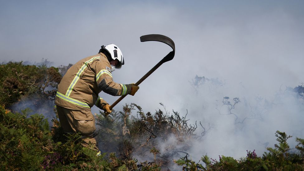A firefighter tackles a wildfire in Cornwall