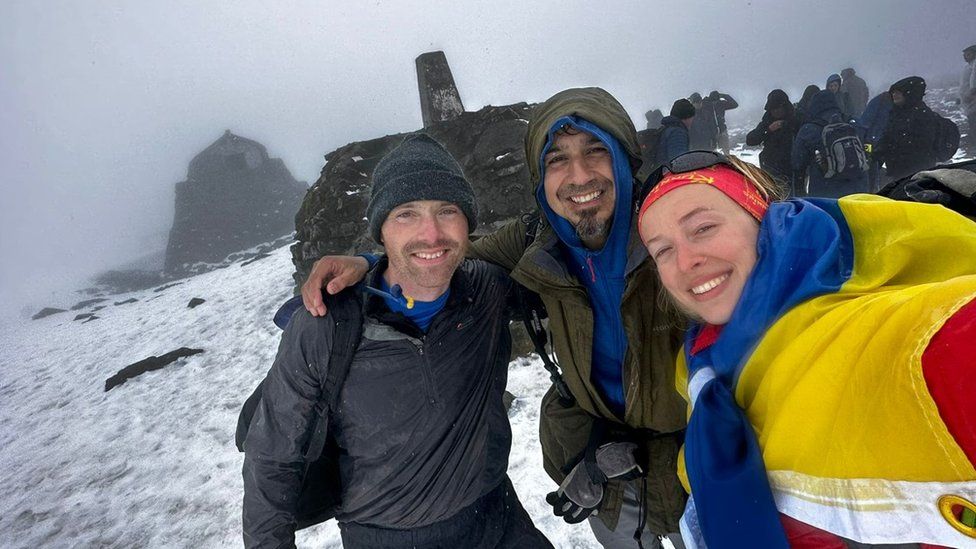 Sofiia Volovyk on the summit of Ben Nevis with support workers