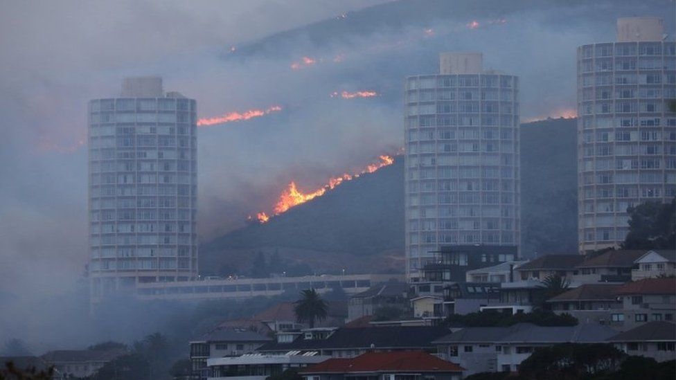 Flames are seen close to the city fanned by strong winds after a bushfire broke out on the slopes of Table Mountain in Cape Town, South Africa, April 19, 2021