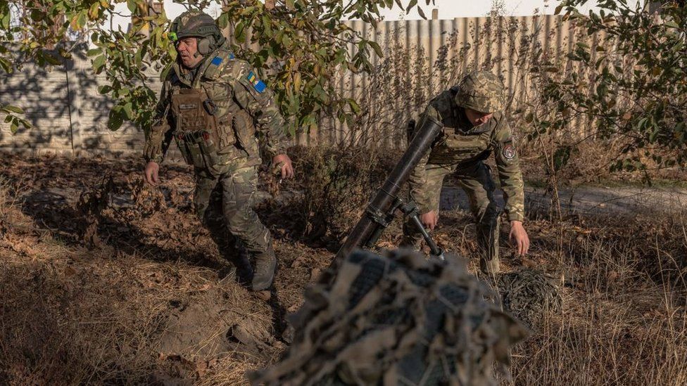 Ukrainian forces fire a mortar over the Dnipro River toward Russian positions