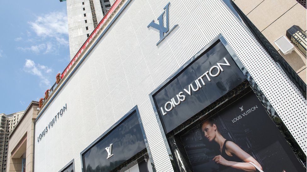 FILEPedestrians walk past a Louis Vuitton LV store in Chongqing China  23 November 2015 French luxury goods firm Louis Vuitton is seeking da  Stock Photo  Alamy