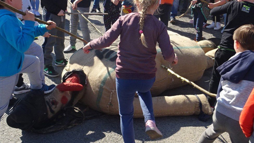 Children beating Judas effigy in Pruchnik, 19 Apr 19
